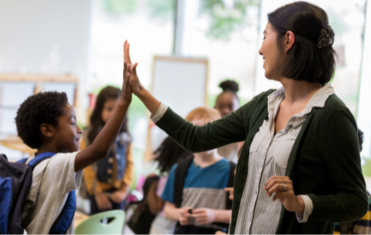 High five from student and teacher