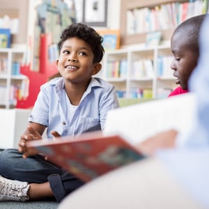 Smiling elementary school boy learning English Language Arts